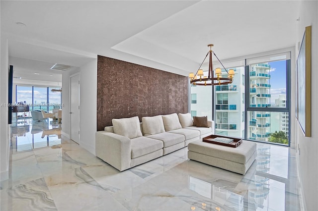 living room featuring an inviting chandelier and floor to ceiling windows