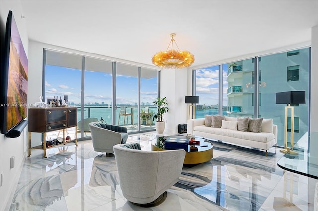 living room featuring a water view, floor to ceiling windows, and a notable chandelier