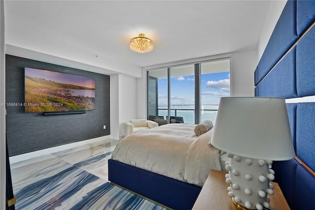 bedroom featuring access to exterior, floor to ceiling windows, and a water view