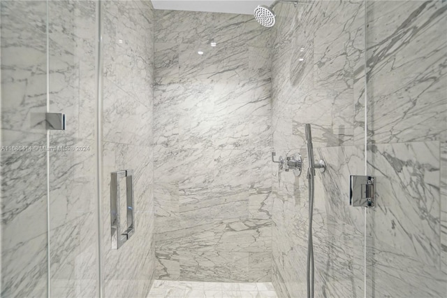 bathroom featuring a shower with shower door