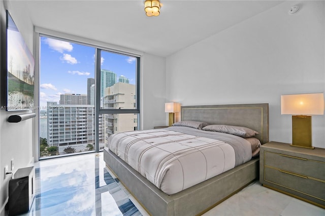 bedroom with floor to ceiling windows and multiple windows