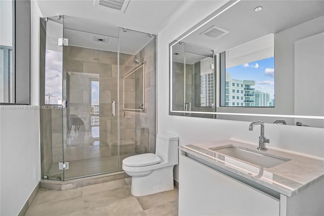 bathroom with vanity, toilet, and a shower with shower door