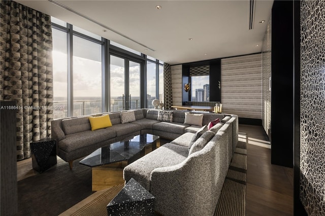 living room with hardwood / wood-style flooring and a wall of windows