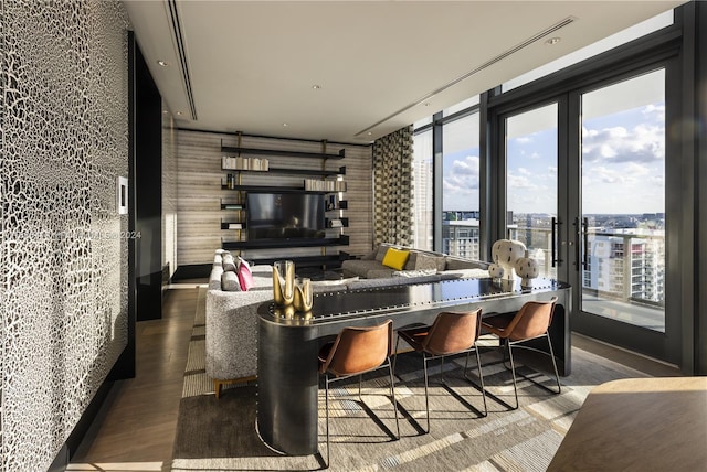 living room with dark hardwood / wood-style flooring and french doors