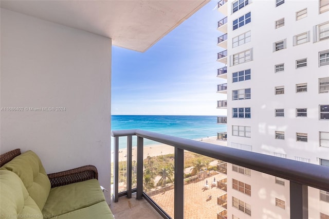 balcony featuring a water view and a beach view