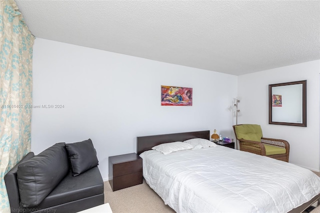 carpeted bedroom featuring a textured ceiling