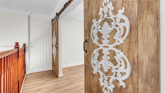 4795 S Classical Blvd, Delray Beach, FL 33445 - room details with baseboards, ornamental molding, a barn door, and wood finished floors