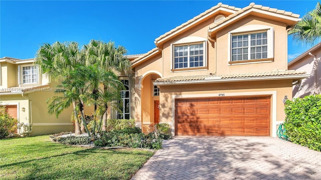 4795 S Classical Blvd, Delray Beach, FL 33445 - mediterranean / spanish home with a tile roof, an attached garage, stucco siding, and decorative driveway