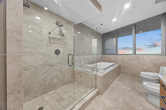 full bathroom featuring separate shower and tub, tile walls, toilet, a bidet, and vanity