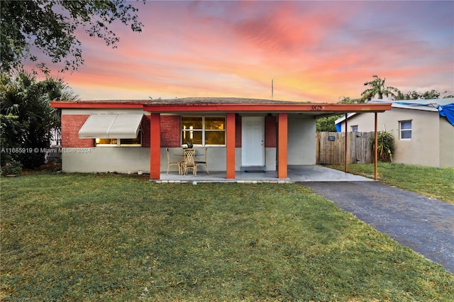 ranch-style home with a lawn