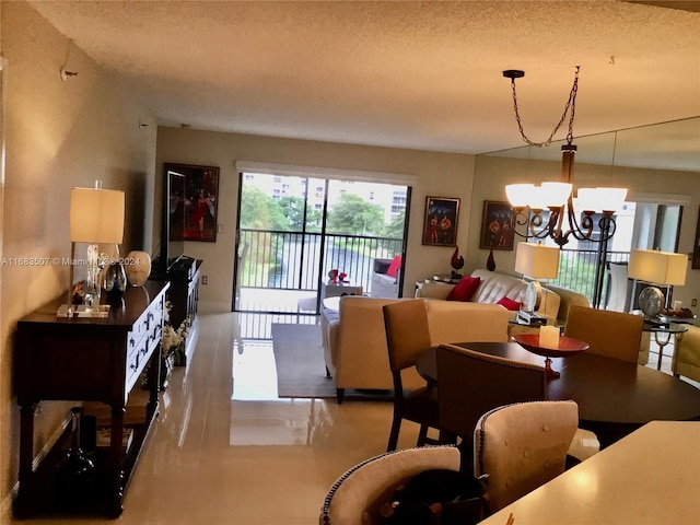 dining area with a textured ceiling and a chandelier