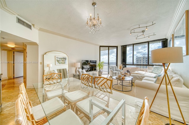 living room with a notable chandelier, a textured ceiling, ornamental molding, and a wall of windows