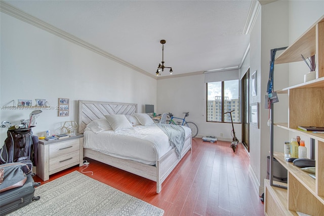 bedroom featuring hardwood / wood-style flooring and ornamental molding