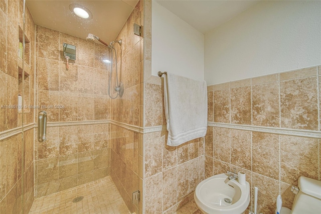 bathroom with tile walls, a bidet, and walk in shower