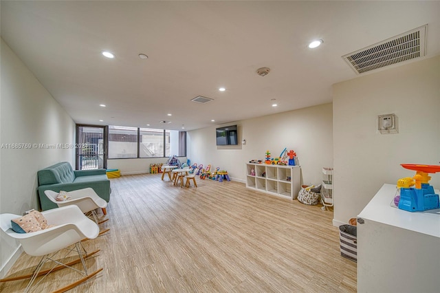 game room with light hardwood / wood-style floors