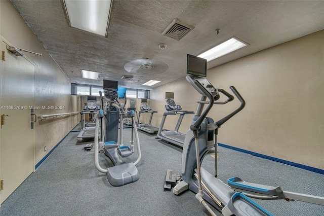 workout area featuring a textured ceiling