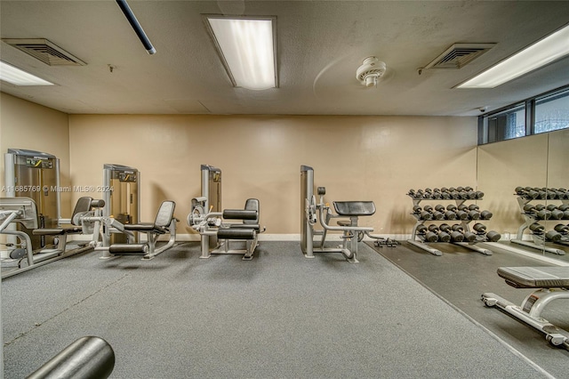 workout area featuring a textured ceiling