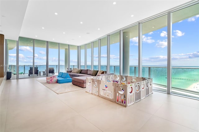 living room featuring a water view and floor to ceiling windows