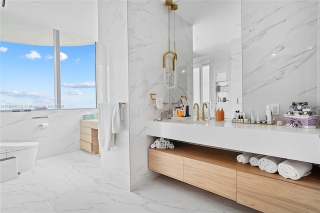 bathroom featuring vanity, toilet, tile walls, and a shower with shower door