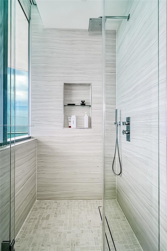 bathroom with a tile shower