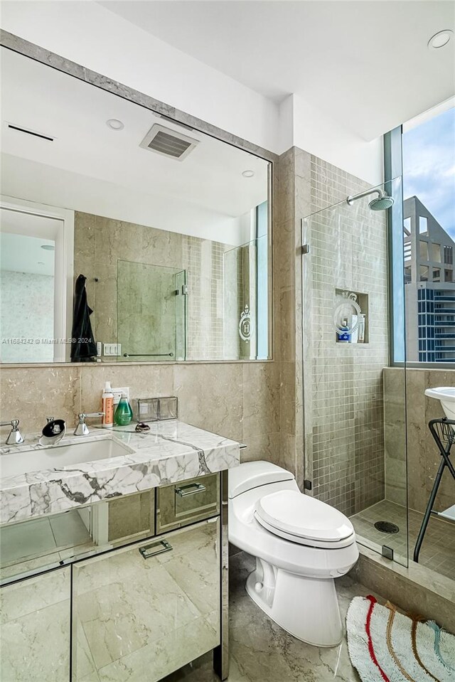 bathroom featuring decorative backsplash, walk in shower, tile walls, toilet, and vanity