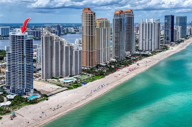 drone / aerial view with a water view and a beach view