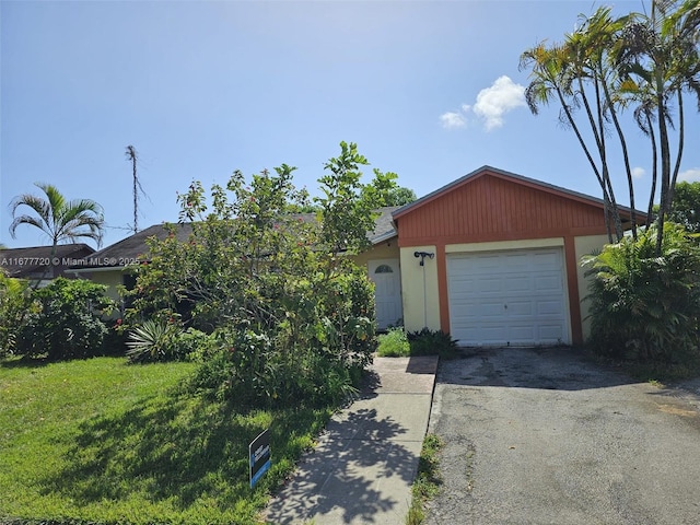 view of front of home with a garage and a front yard