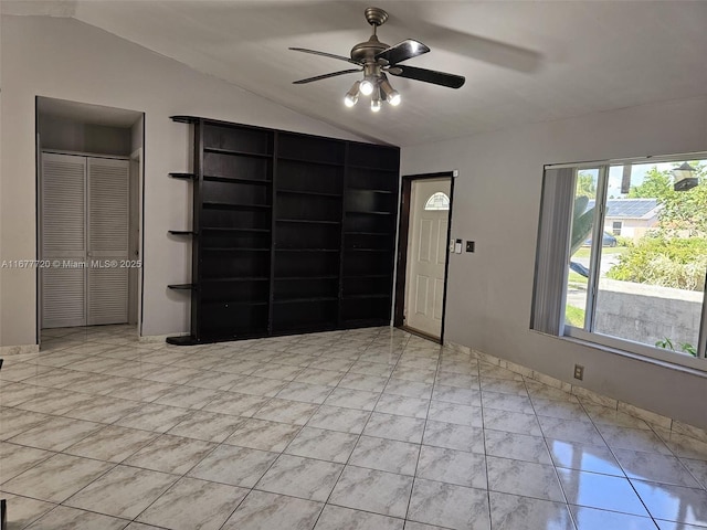 interior space with lofted ceiling and ceiling fan