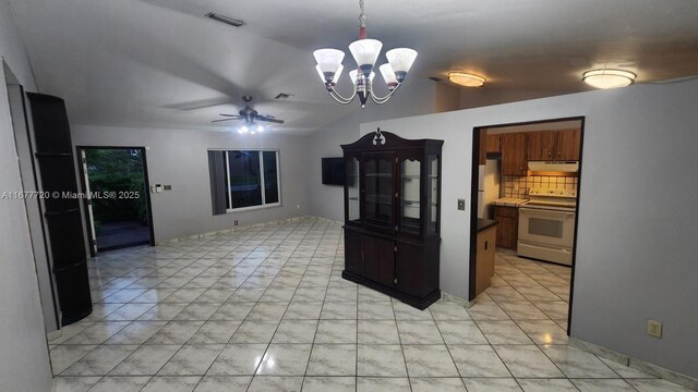 kitchen with vaulted ceiling, ceiling fan with notable chandelier, decorative backsplash, hanging light fixtures, and white appliances