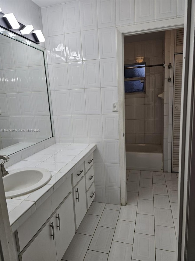 bathroom with tile patterned flooring, vanity, and tile walls