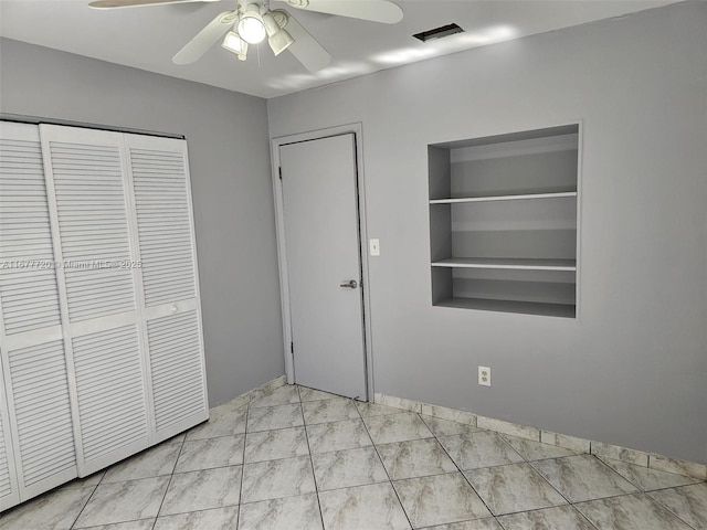 unfurnished bedroom with a closet and ceiling fan