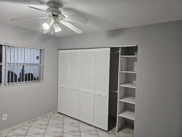 unfurnished bedroom with a closet and ceiling fan