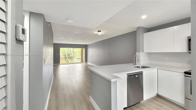3571 Inverrary Dr Unit 203, Lauderhill, FL 33319 - kitchen with a sink, stainless steel dishwasher, a peninsula, light countertops, and light wood-type flooring