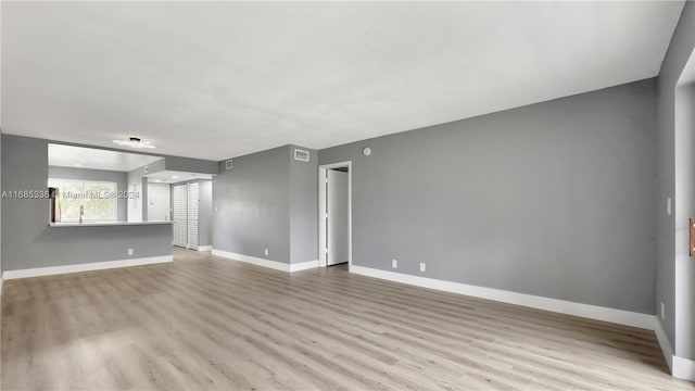 unfurnished living room featuring light hardwood / wood-style flooring