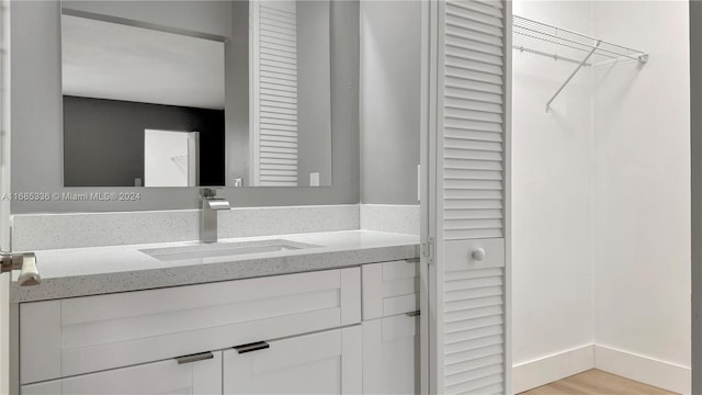 bathroom featuring vanity and hardwood / wood-style floors