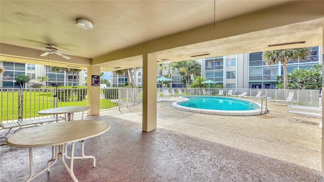 view of pool featuring a patio area, a yard, and ceiling fan