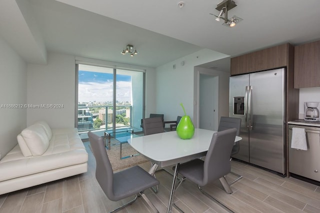 dining space with light hardwood / wood-style floors