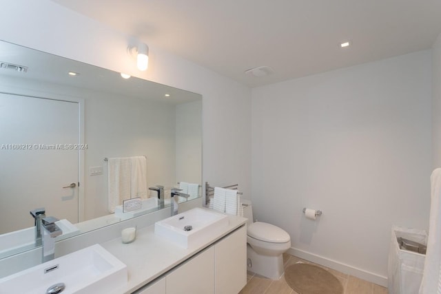 bathroom featuring vanity, wood-type flooring, and toilet