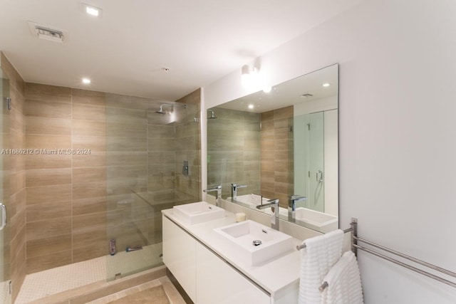 bathroom with vanity, tile patterned flooring, and an enclosed shower