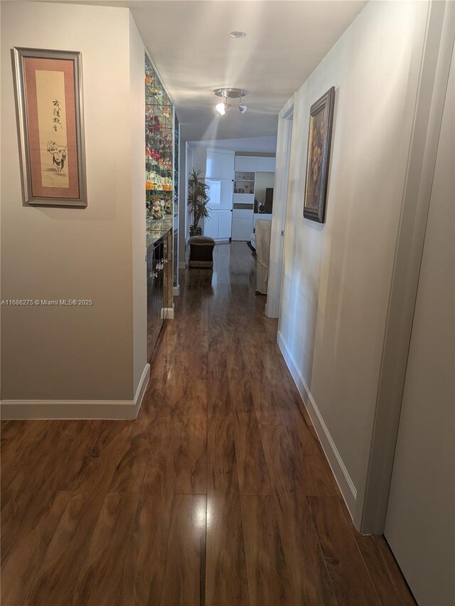 corridor with dark hardwood / wood-style floors