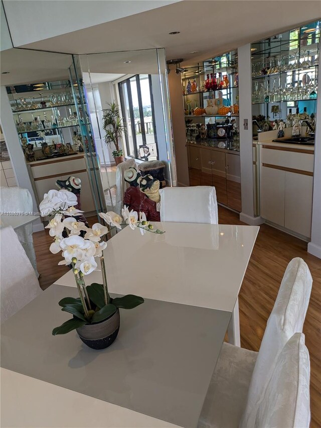 dining space featuring indoor wet bar and light wood-type flooring