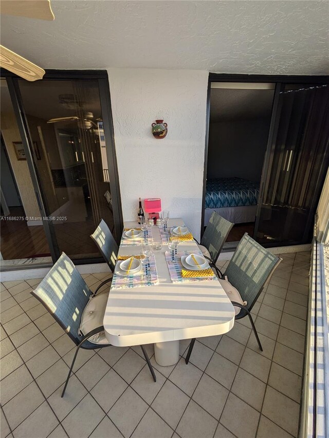 tiled dining area featuring a textured ceiling