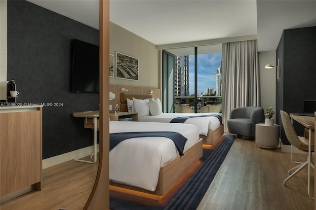 bedroom featuring hardwood / wood-style floors and floor to ceiling windows