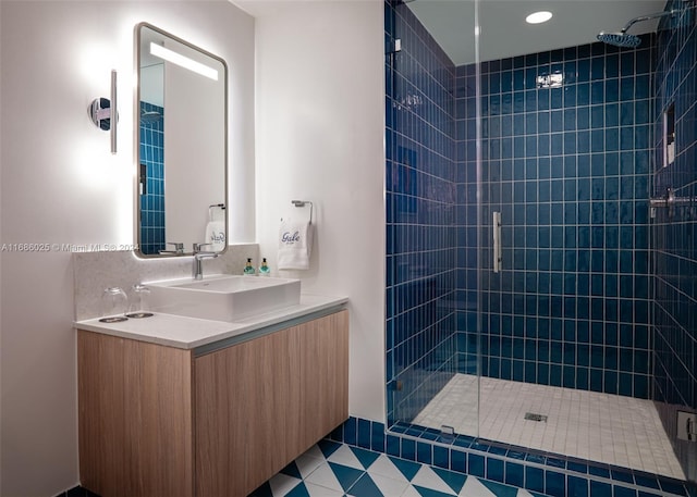 bathroom with vanity, tile patterned flooring, and walk in shower