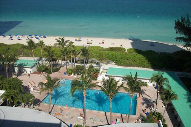 view of pool featuring a view of the beach and a water view