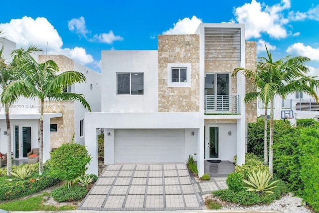 view of front of house featuring a garage and a balcony