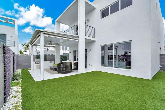 back of house featuring a lawn, ceiling fan, a patio area, outdoor lounge area, and area for grilling