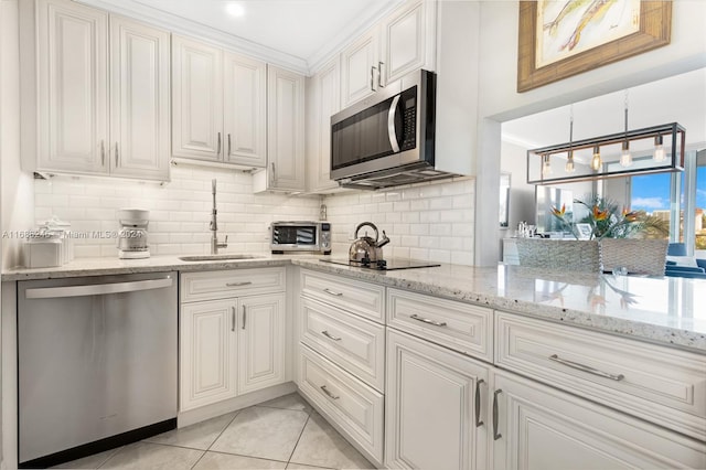 180 Isle Of Venice Dr Unit 432, Fort Lauderdale, FL 33301 - kitchen featuring appliances with stainless steel finishes, a sink, decorative backsplash, white cabinetry, and crown molding