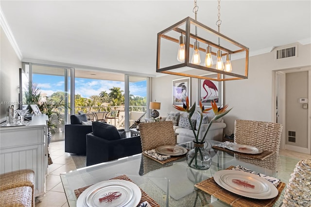 dining space with light tile patterned flooring, ornamental molding, an inviting chandelier, and floor to ceiling windows