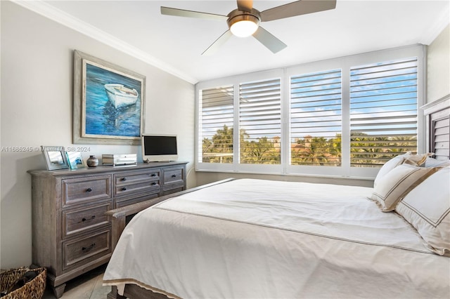 bedroom with ceiling fan and crown molding